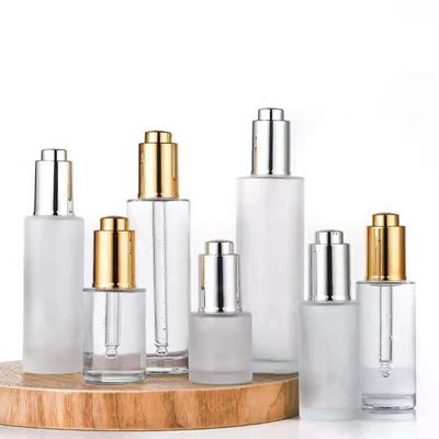 Flacon compte-goutte transparent à bouton poussoir